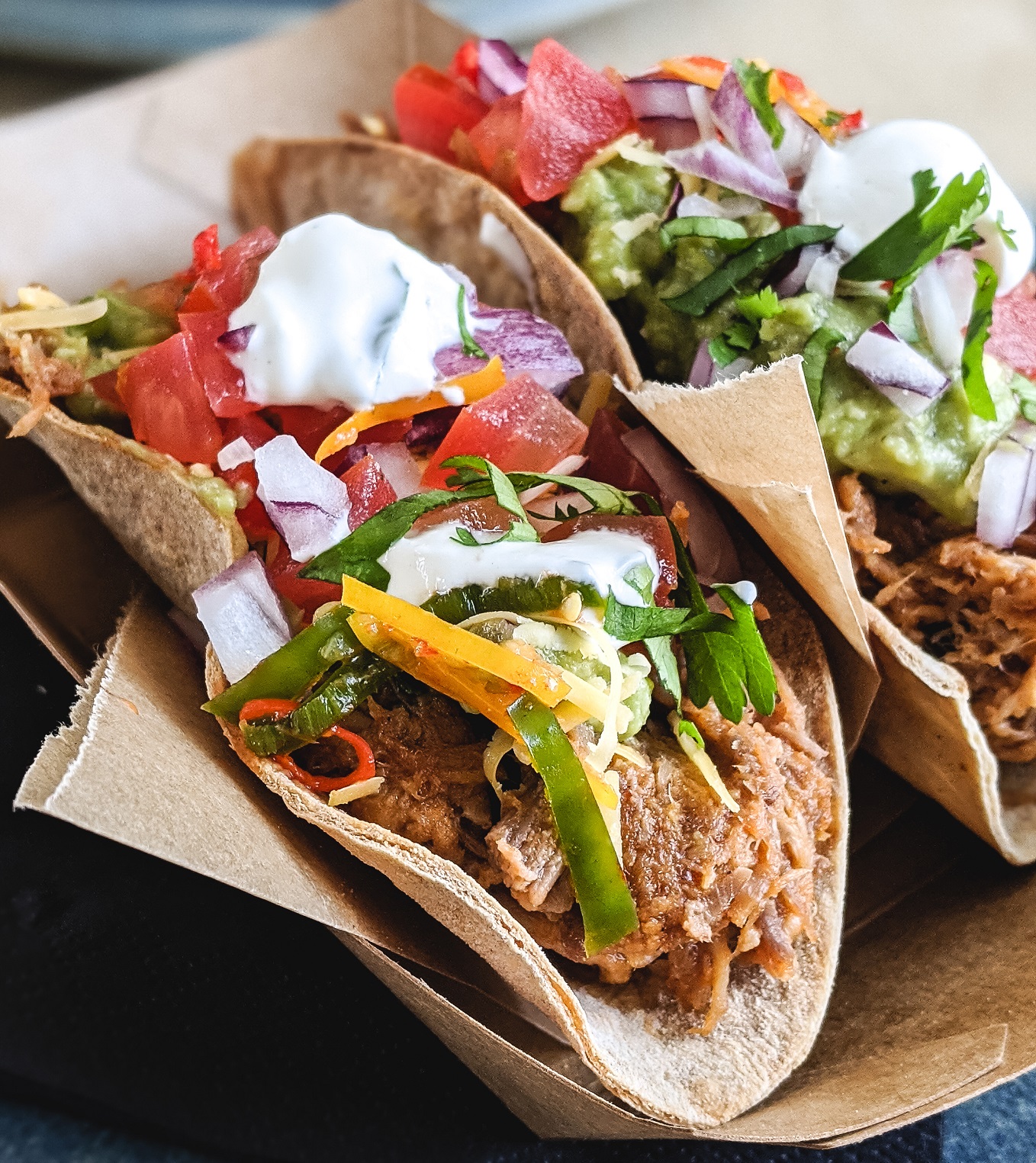 Tacos with pulled pork fresh vegetables and cream