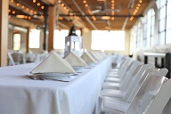 Tables lined with white linen and set with white napkins